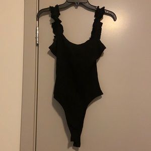 Black ribbed bodysuit with ruffled straps